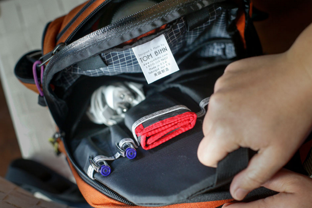 A close up view of a Tom Bihn Synapse 19 backpack opened up to show its inside contents, from a different angle.