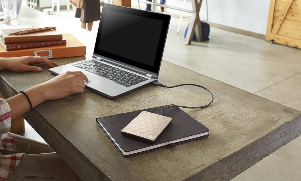 A Seagate external hard drive connected to a laptop.