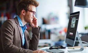Man using Adobe Premiere Pro on iMac