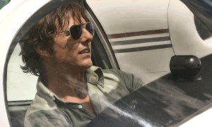 Tom Cruise as Barry Seal piloting a plane in American Made.