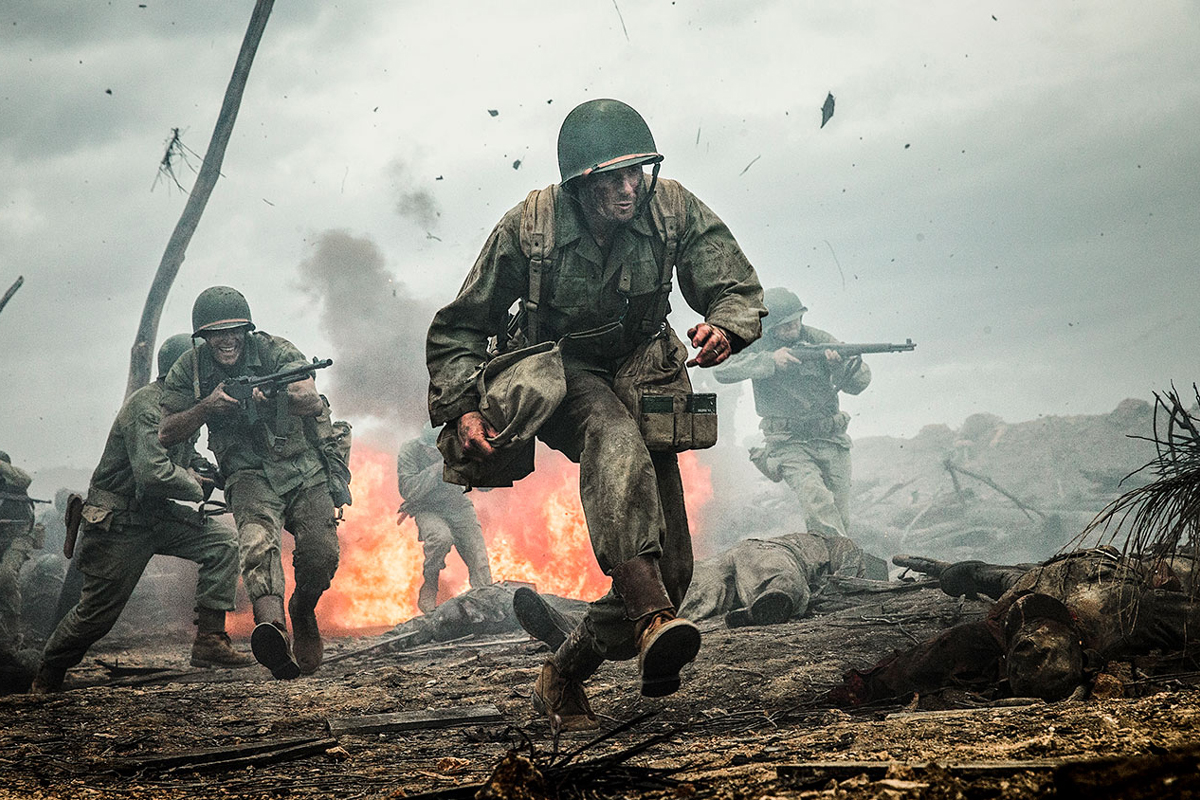 A soldier runs through a battlefield in "Hacksaw Ridge."