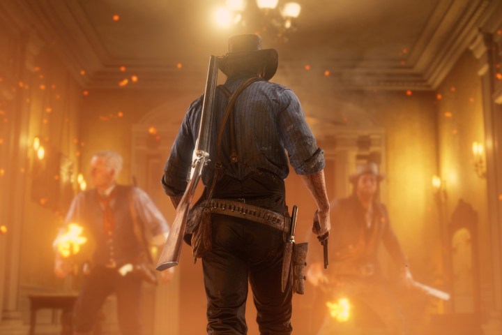 Arthur Morgan walks into a burning house in Red Dead Redemption 2.