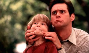 Jim Carrey pulls back on a boys face in Liar Liar.