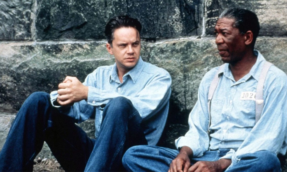 Andy and Red sit on the ground in The Shawshank Redemption.