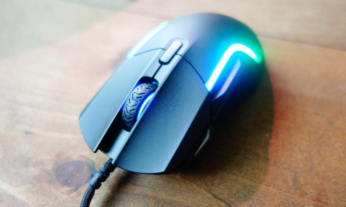 The SteelSeries Rival 5 gaming mouse on a table.