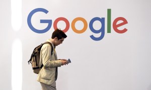 A man walks past the logo of the US multinational technology company Google during the VivaTech trade fair.