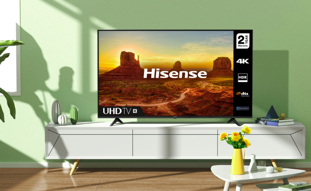 A Hisense 70-inch Class A6G 4K TV on a white media console. Sunlight and shadows are cast across the living room.