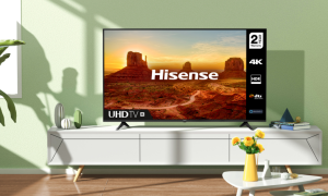 A Hisense 70-inch Class A6G 4K TV on a white media console. Sunlight and shadows are cast across the living room.