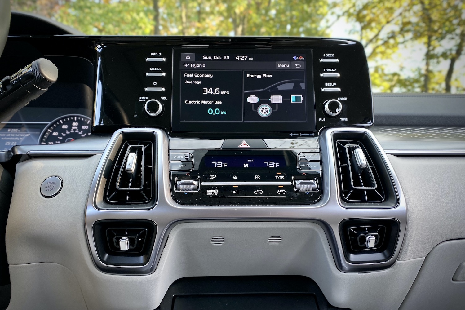Close of up 2021 Kia Sorento Hybrid center console with trees in the background.