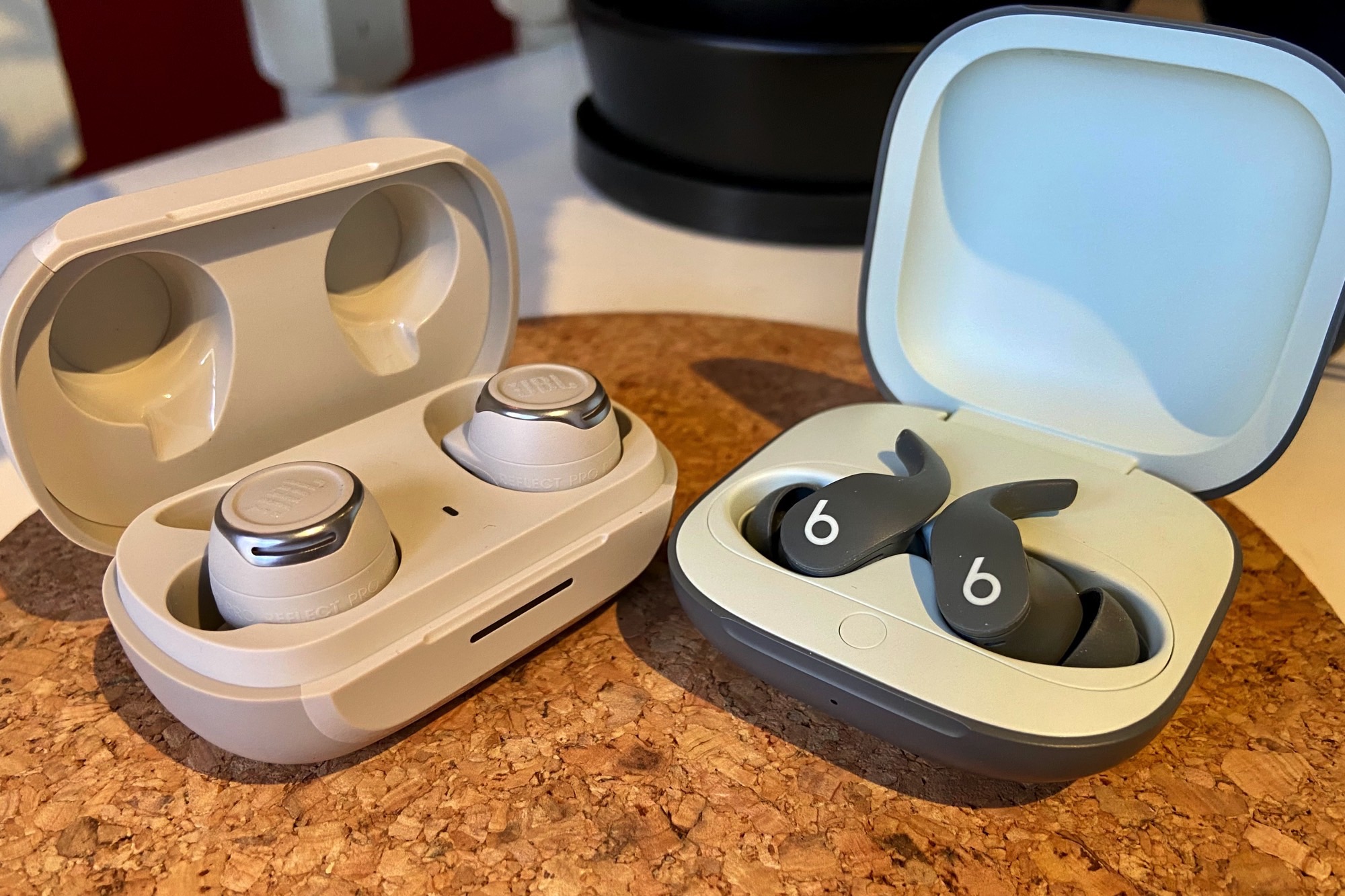 JBL Reflect Flow Pro charging case seen next to Beats Fit Pro.