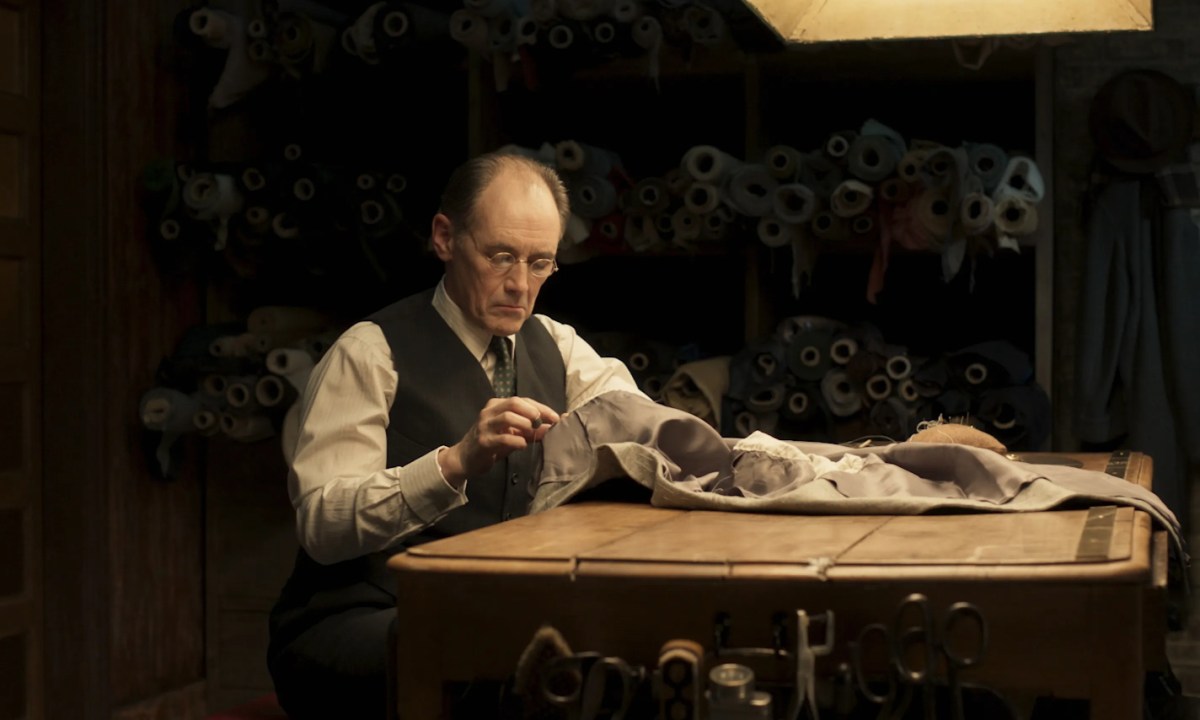 Mark Rylance stitching together a suit in The Outfit