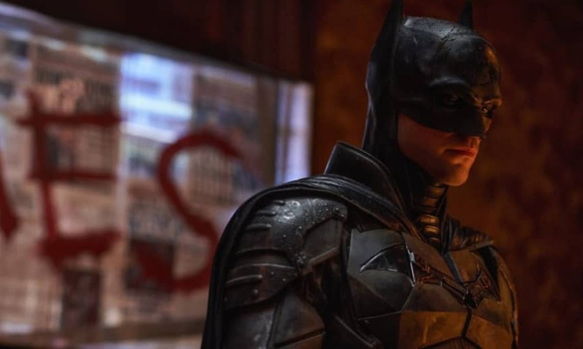 Batman stares down at a crime scene in The Batman.