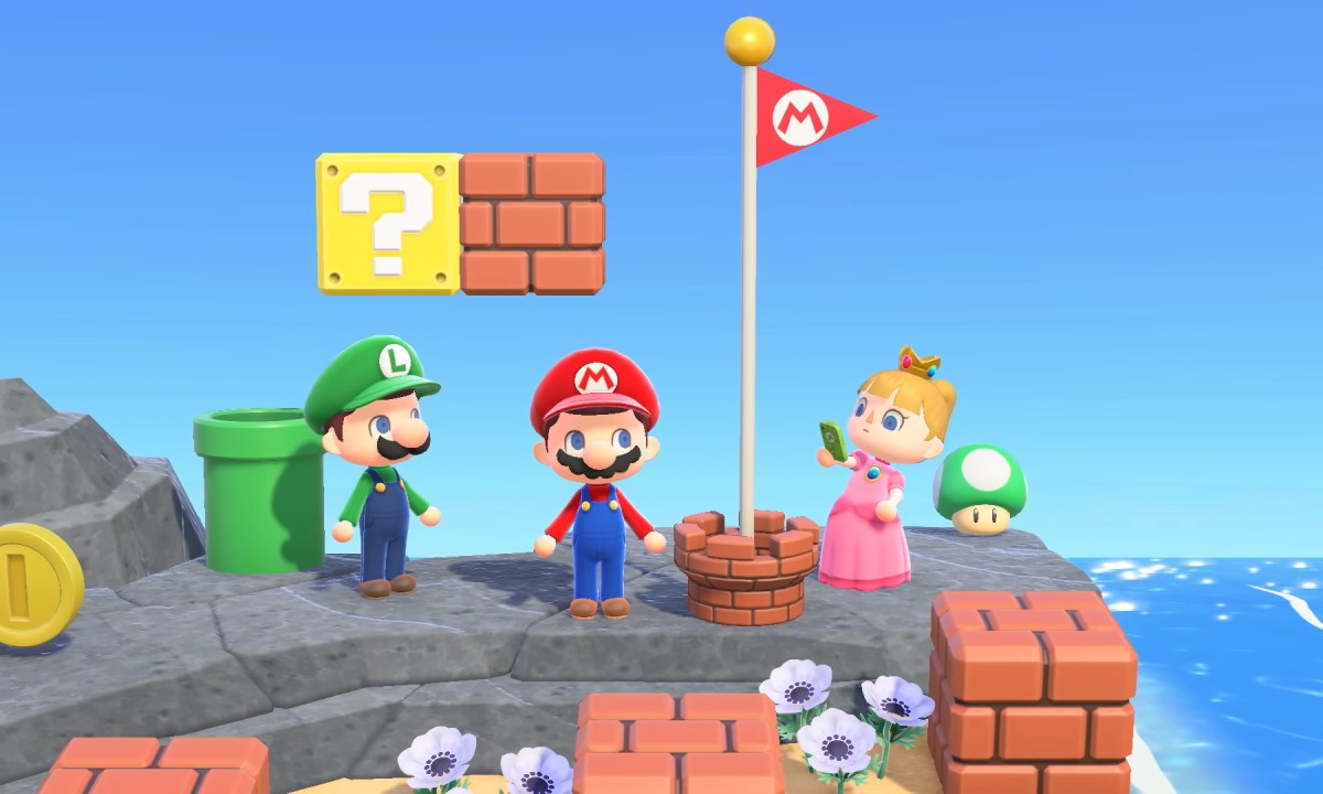 Mario, Luigi, and Peach stand around a Mario flag in Animal Crossing: New Horizons.
