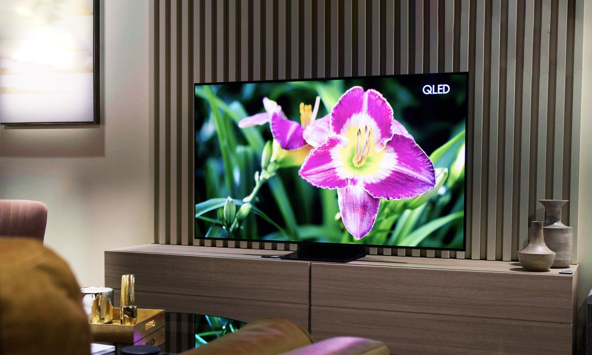 Samsung S95B OLED TV with image of a bright flower on screen.