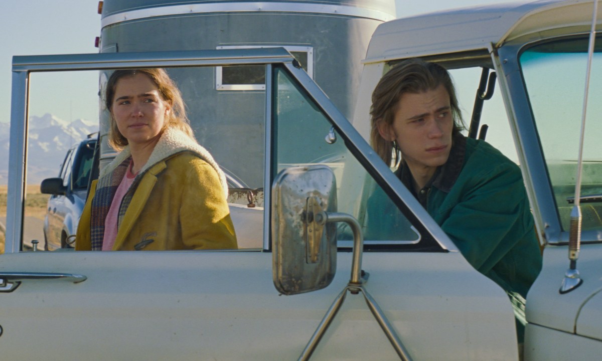 Haley Lu Richardson and Owen Teague stand next to a truck in Montana Story.