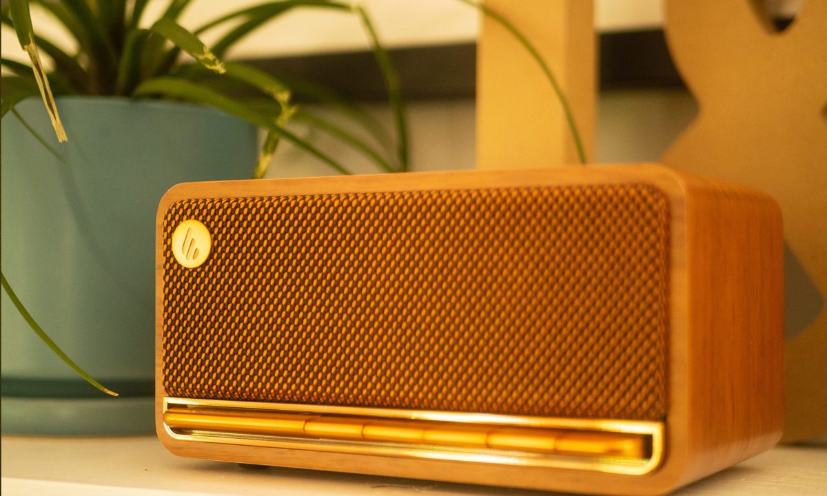 An Edifier MP230 Bluetooth speaker is sitting on a mantle next to a plant and some decorative letters.
