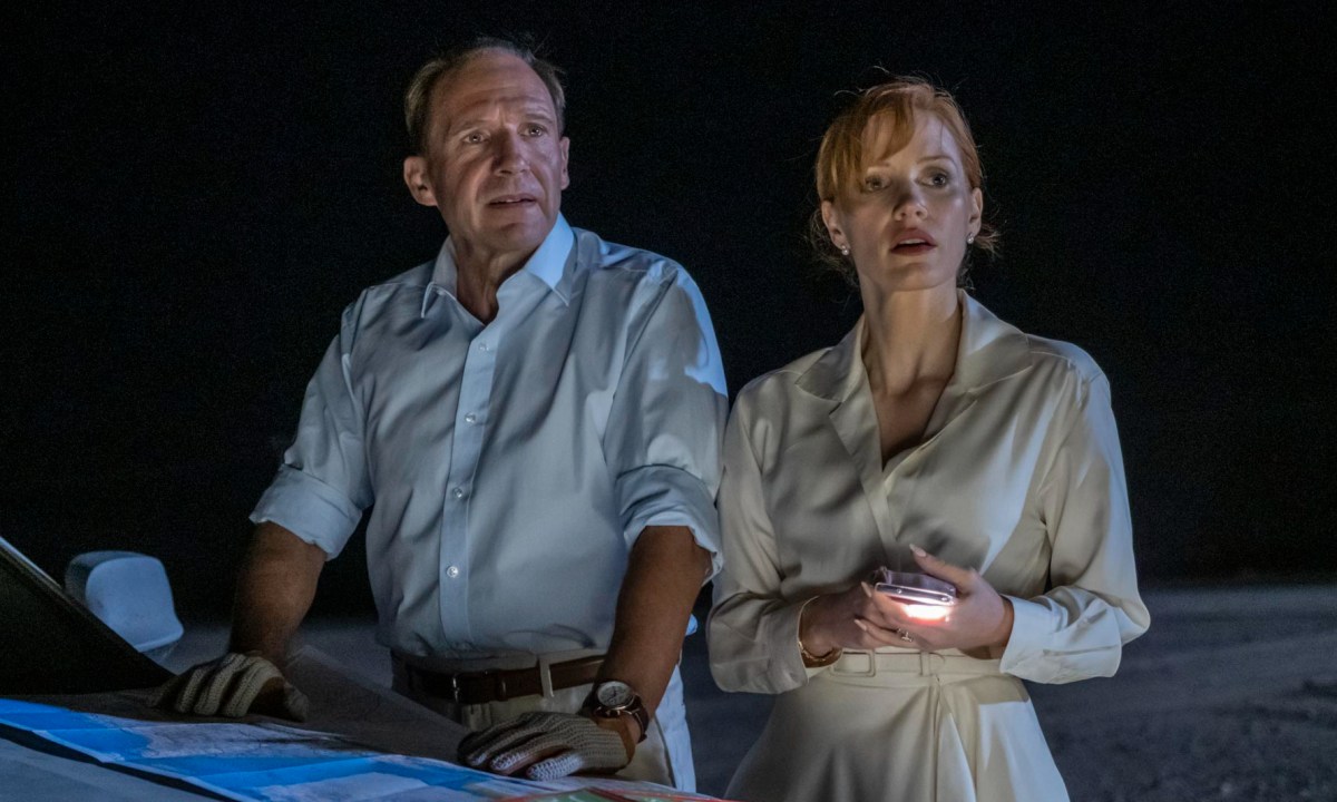 Ralph Fiennes and Jessica Chastain stand by a car together in The Forgiven.