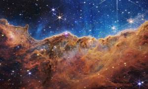 This landscape of “mountains” and “valleys” speckled with glittering stars is actually the edge of a nearby, young, star-forming region called NGC 3324 in the Carina Nebula. Captured in infrared light by NASA’s new James Webb Space Telescope, this image reveals for the first time previously invisible areas of star birth.