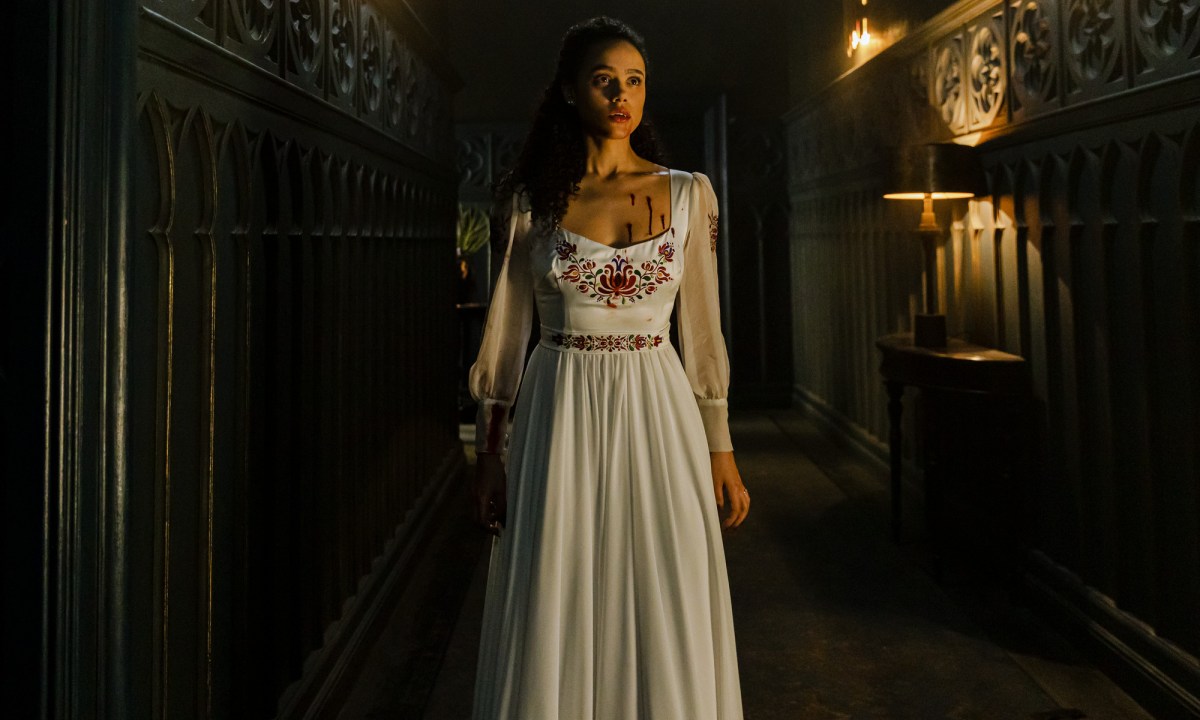 Nathalie Emmanuel wears a bloodied white dress in The Invitation.