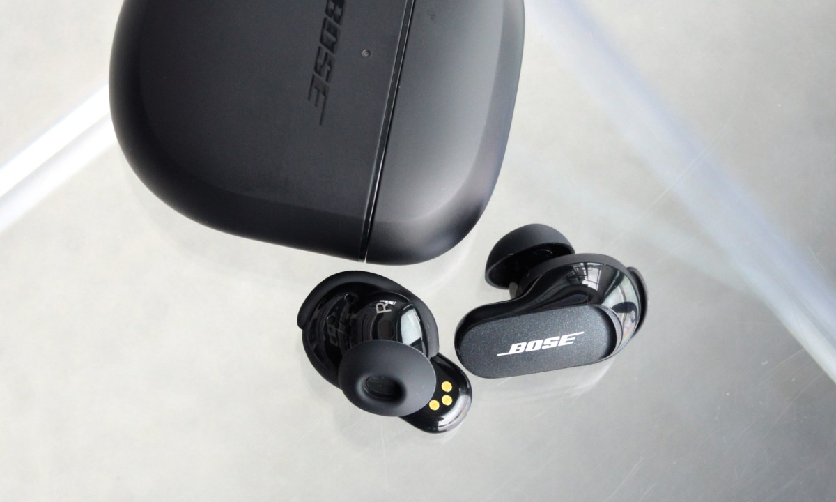 Bose QuietComfort Earbuds II beside charging case.