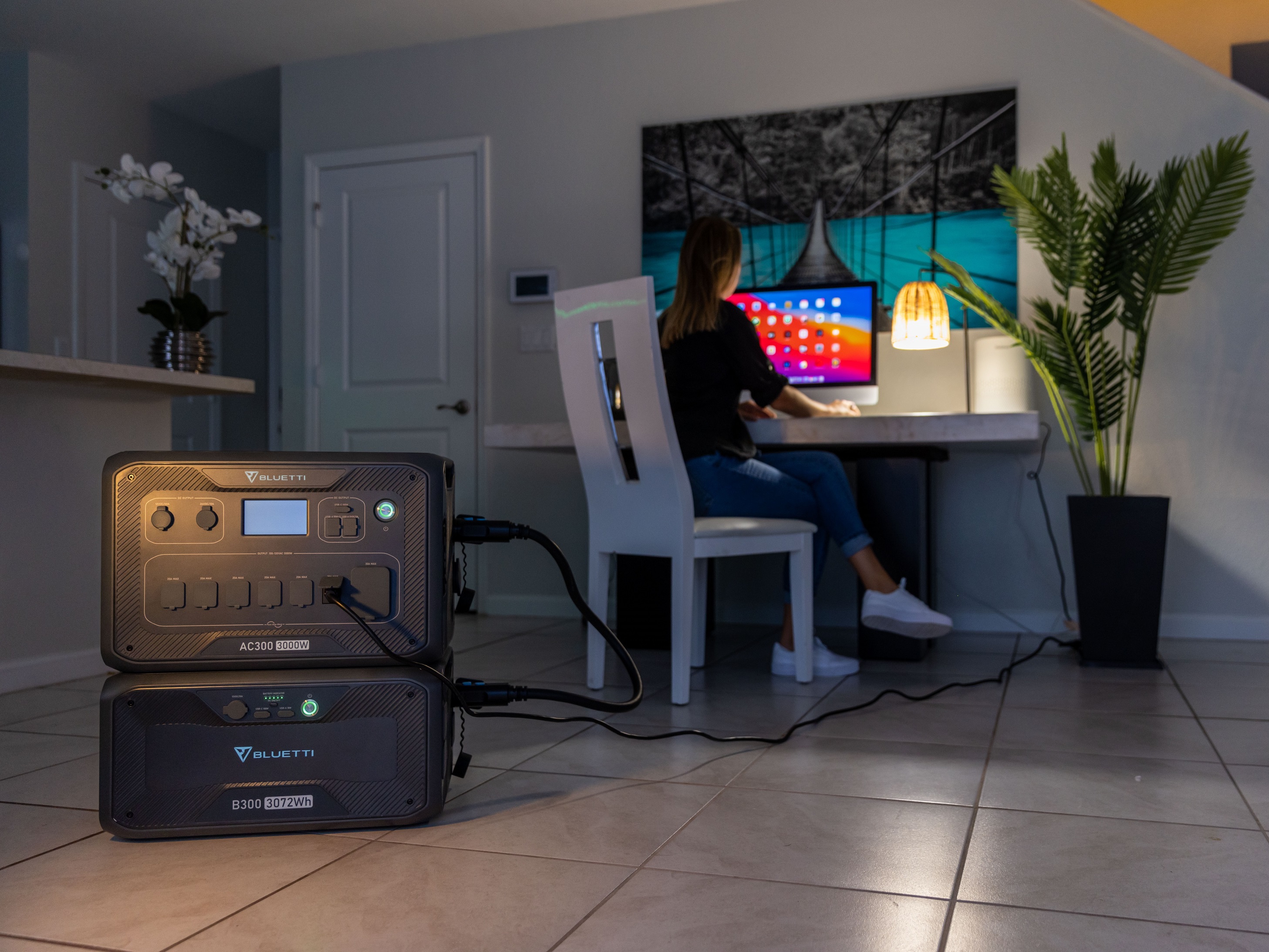 Bluetti AC300 portable power station supplying power to desktop during outage.