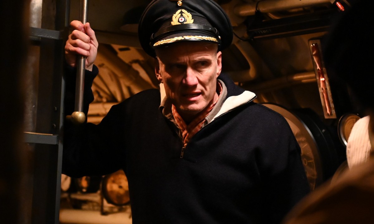 Dolph Lundgren holds onto a pipe inside a U-Boat in a scene from Operation Seawolf.