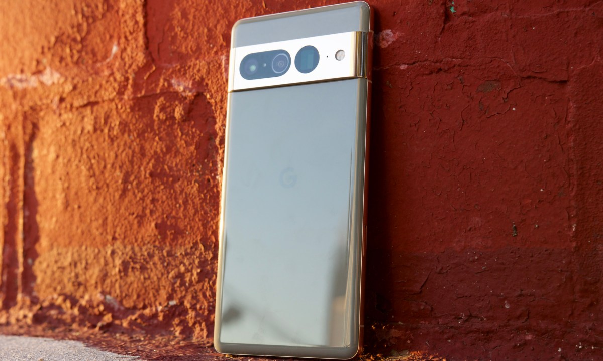 Google Pixel 7 Pro standing up against a red brick wall.