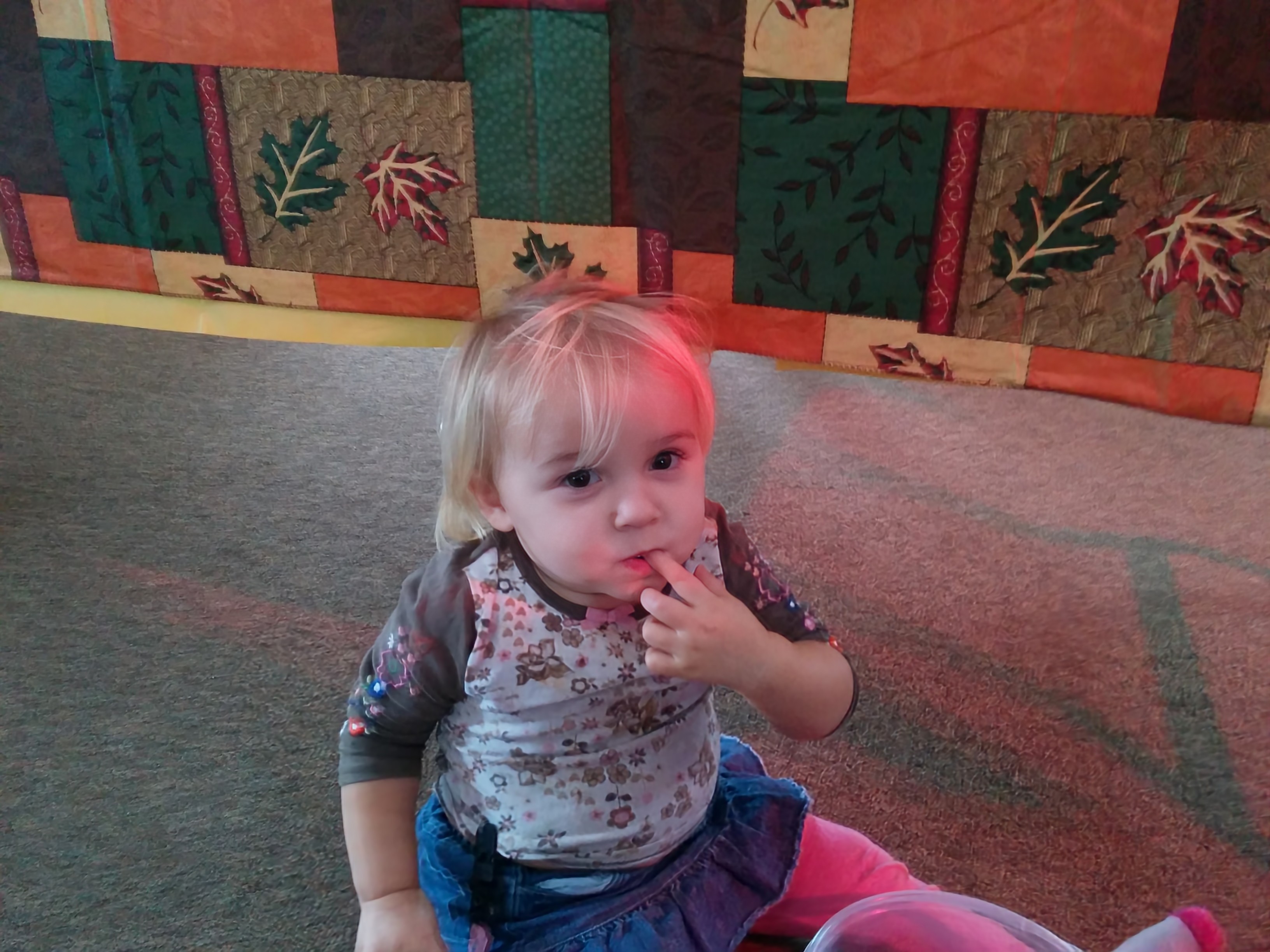 Photo of a toddler sucking her thumb.