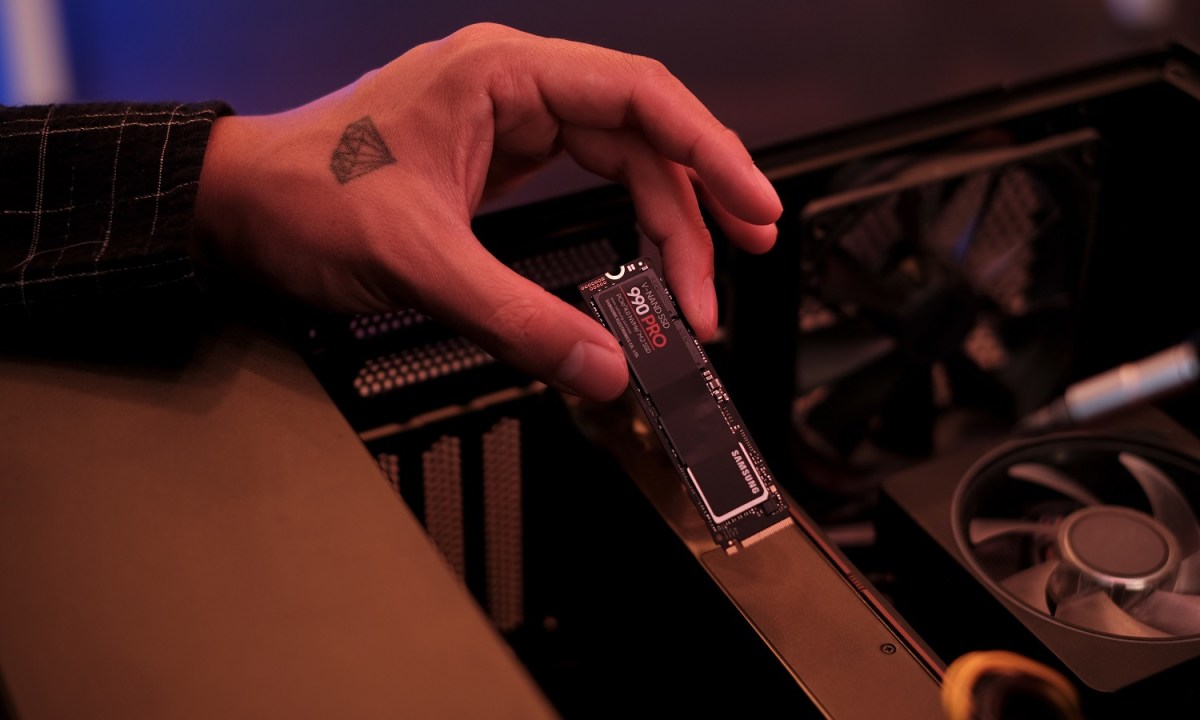 The Samsung 990 Pro SSD being installed in a PC.