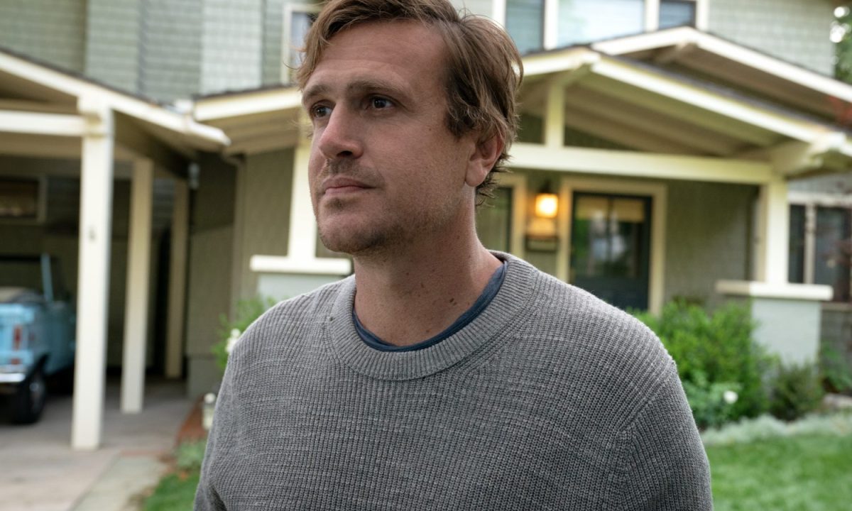 Jason Segel stands near a house in Shrinking.