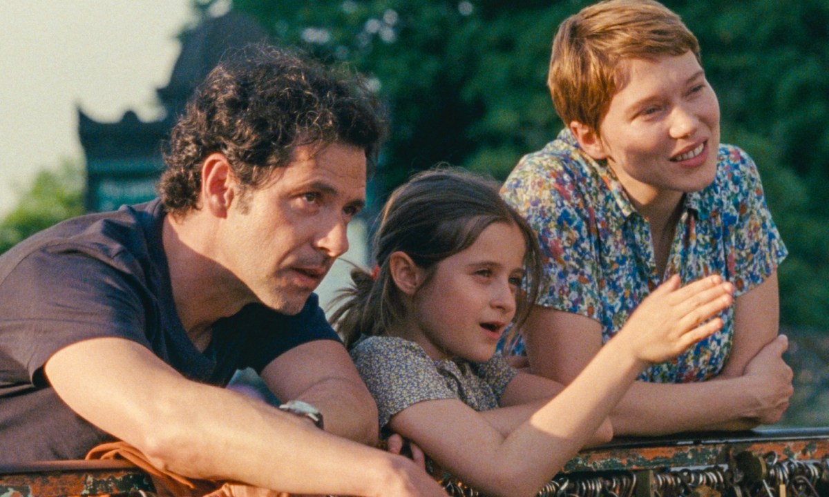 Melvil Poupaud, Camille Leban Martins, and Léa Seydoux lean on a railing together in One Fine Morning.