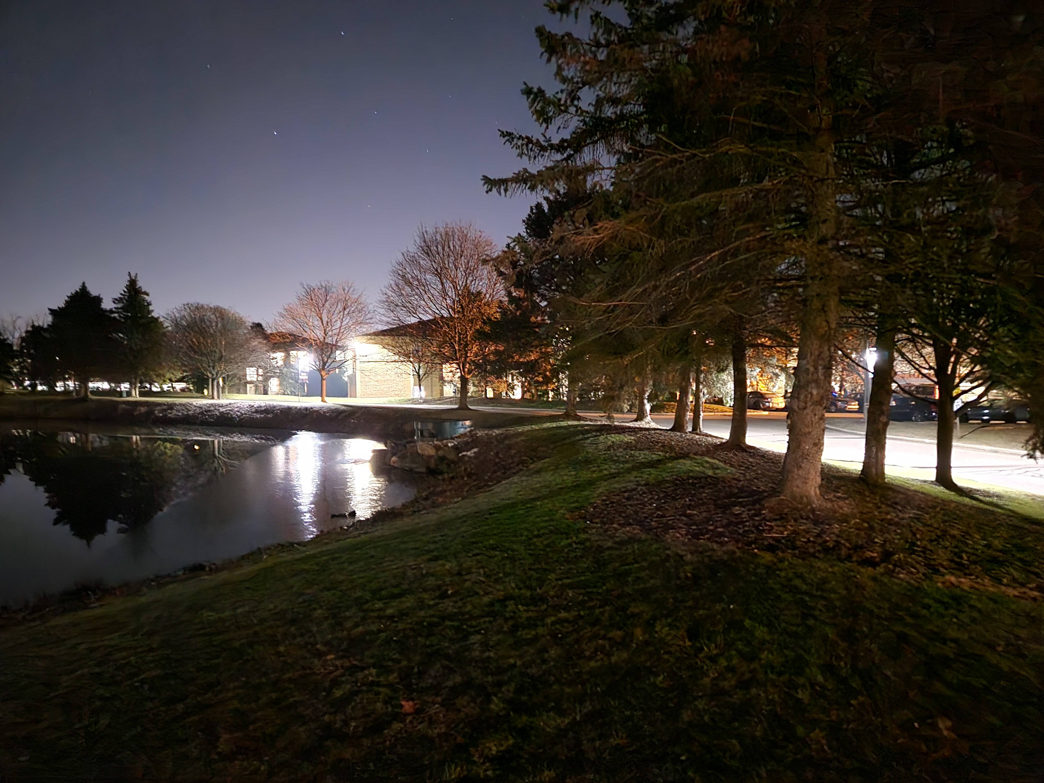 Samsung Galaxy S23 Plus photo of a hill and pond at night.