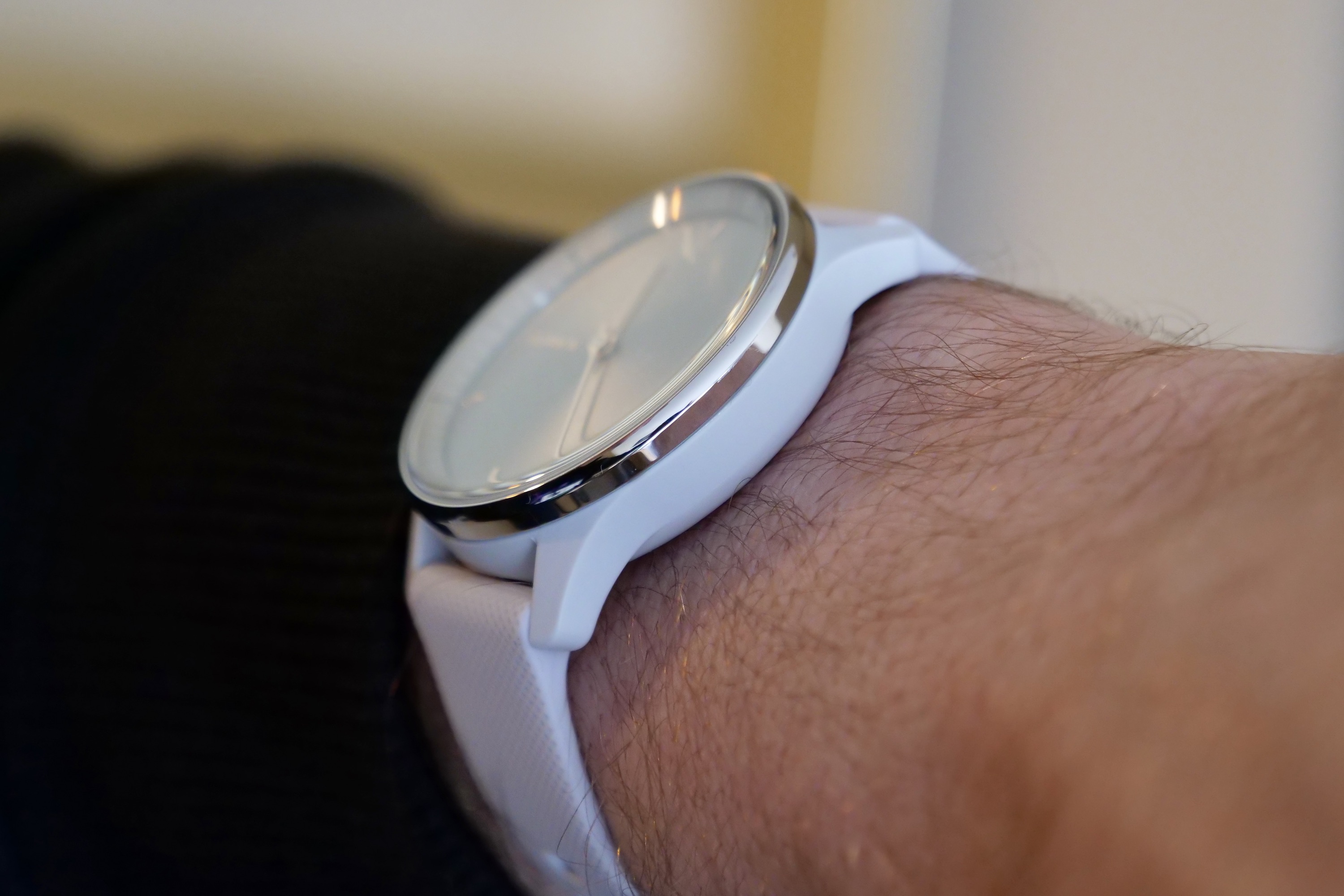 The side of the Garmin Vivomove Trend on a person's wrist.