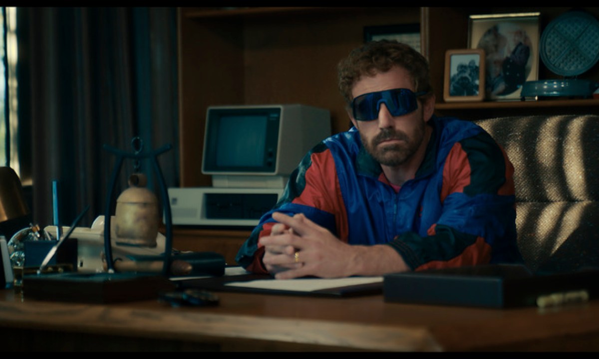 Ben Affleck sits a table with sunglasses on in Air.