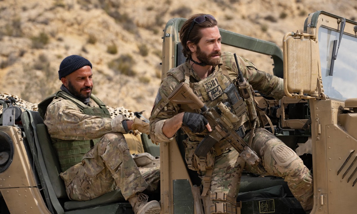 Dar Salim and Jake Gyllenhaal sit in a military Humvee together in The Covenant.