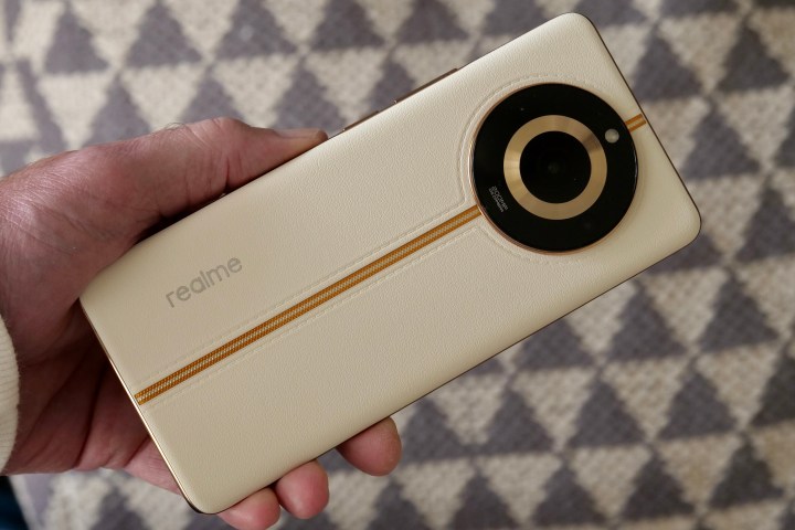 A person holding the Realme 11 Pro+.