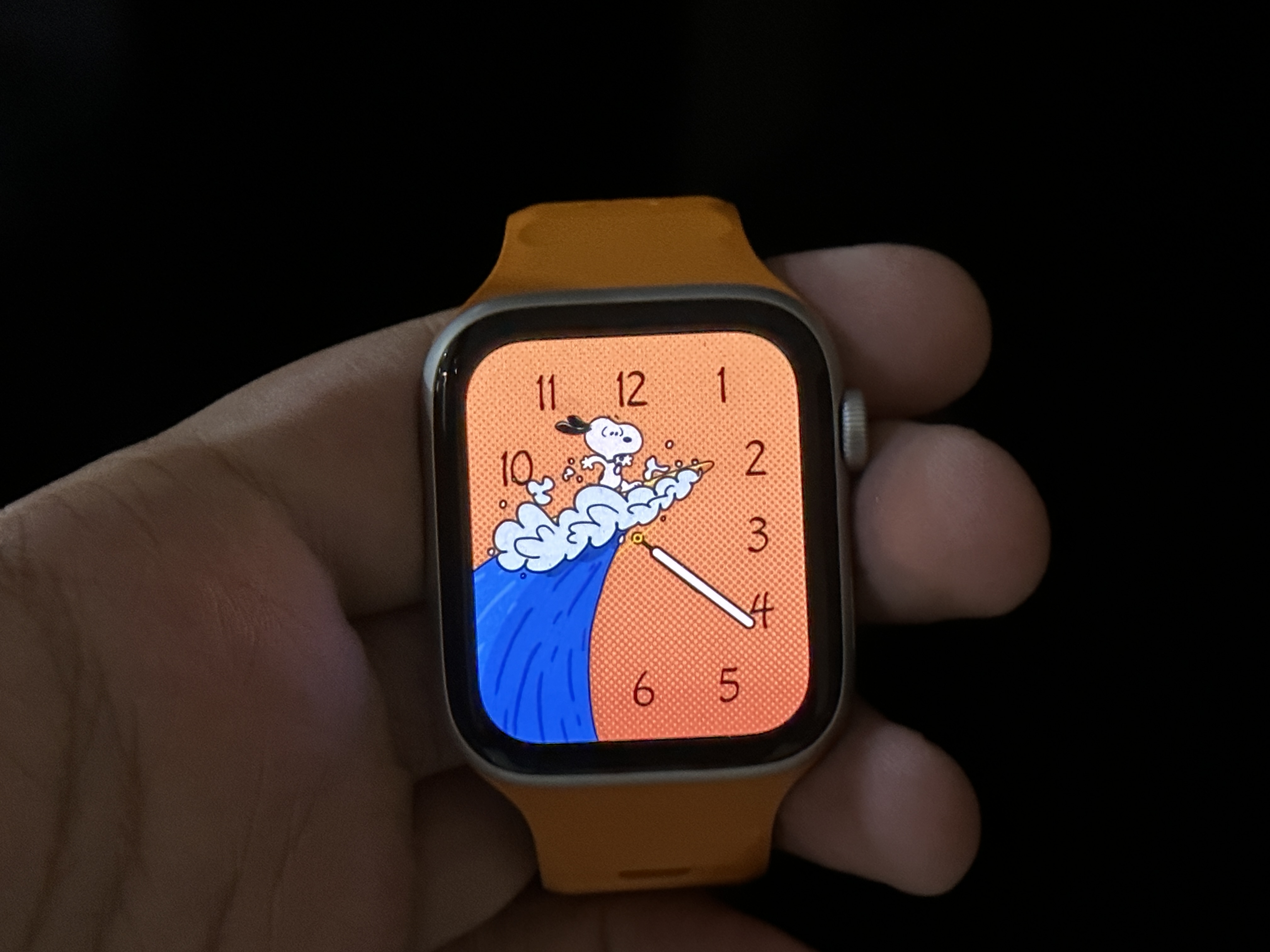 Snoopy Watch Face with Pumpkin background on Apple Watch SE.