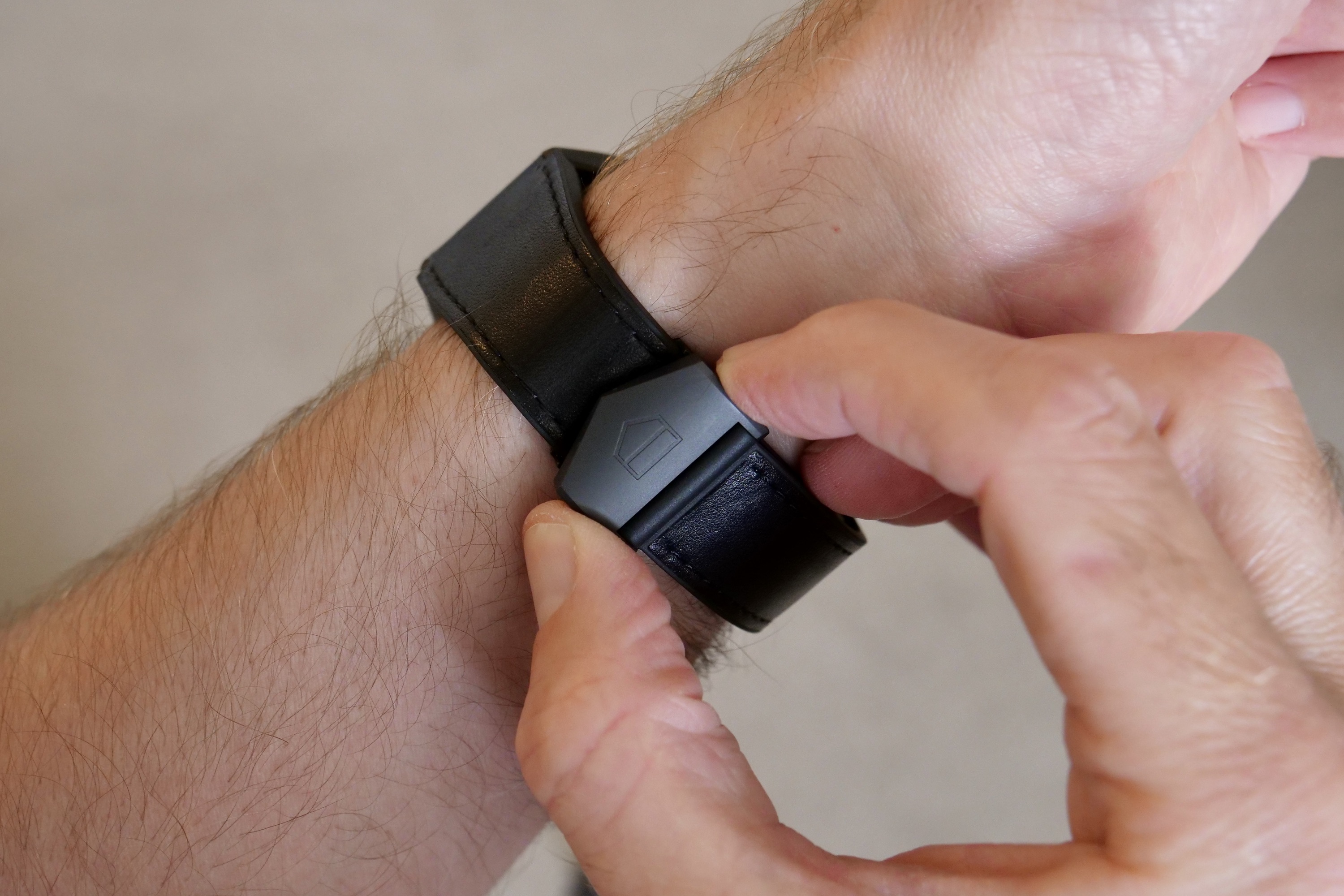 Undoing the clasp on the Tag Heuer Connected Calibre E4 Bright Black Edition.