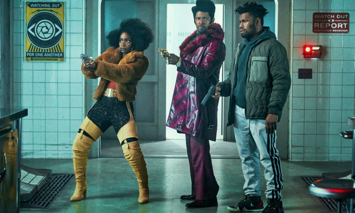 Three people aim their guns in They Cloned Tyrone.