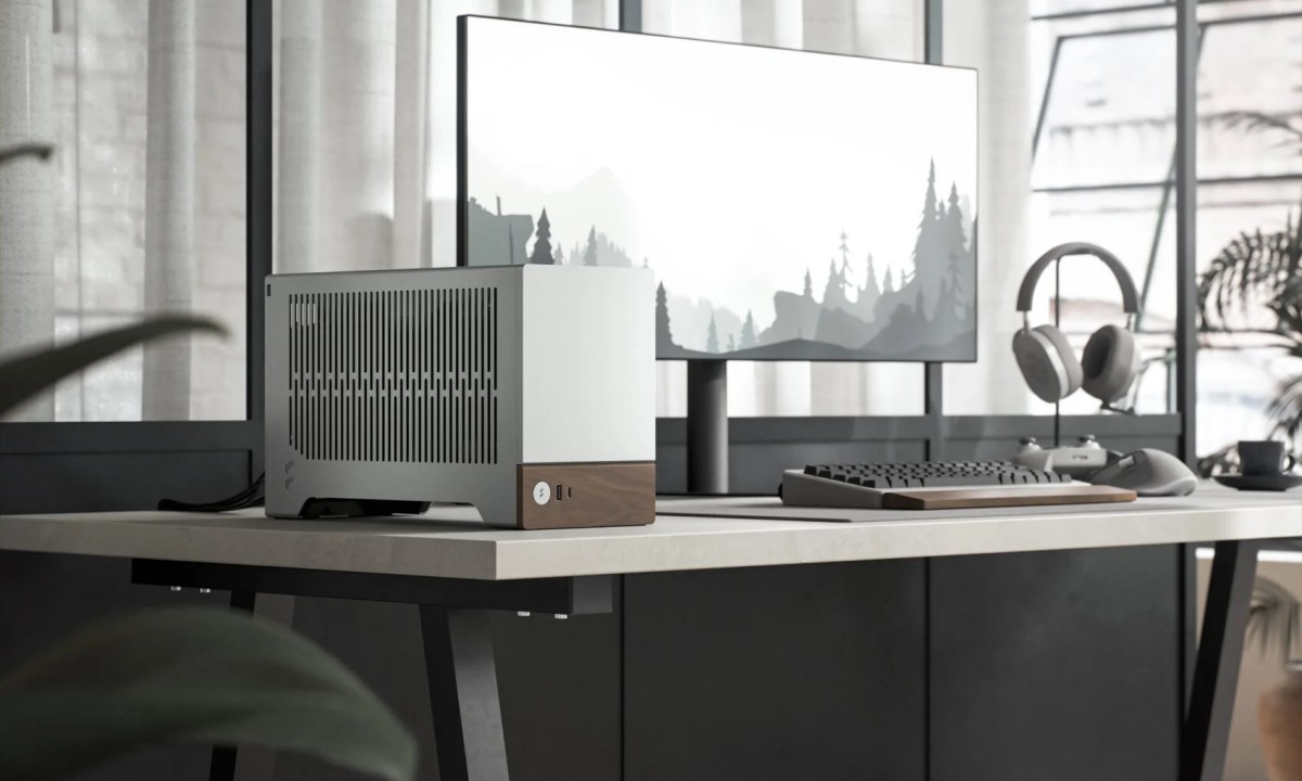 The Fractal Design Terra mini-ITX case in silver placed on a desk.