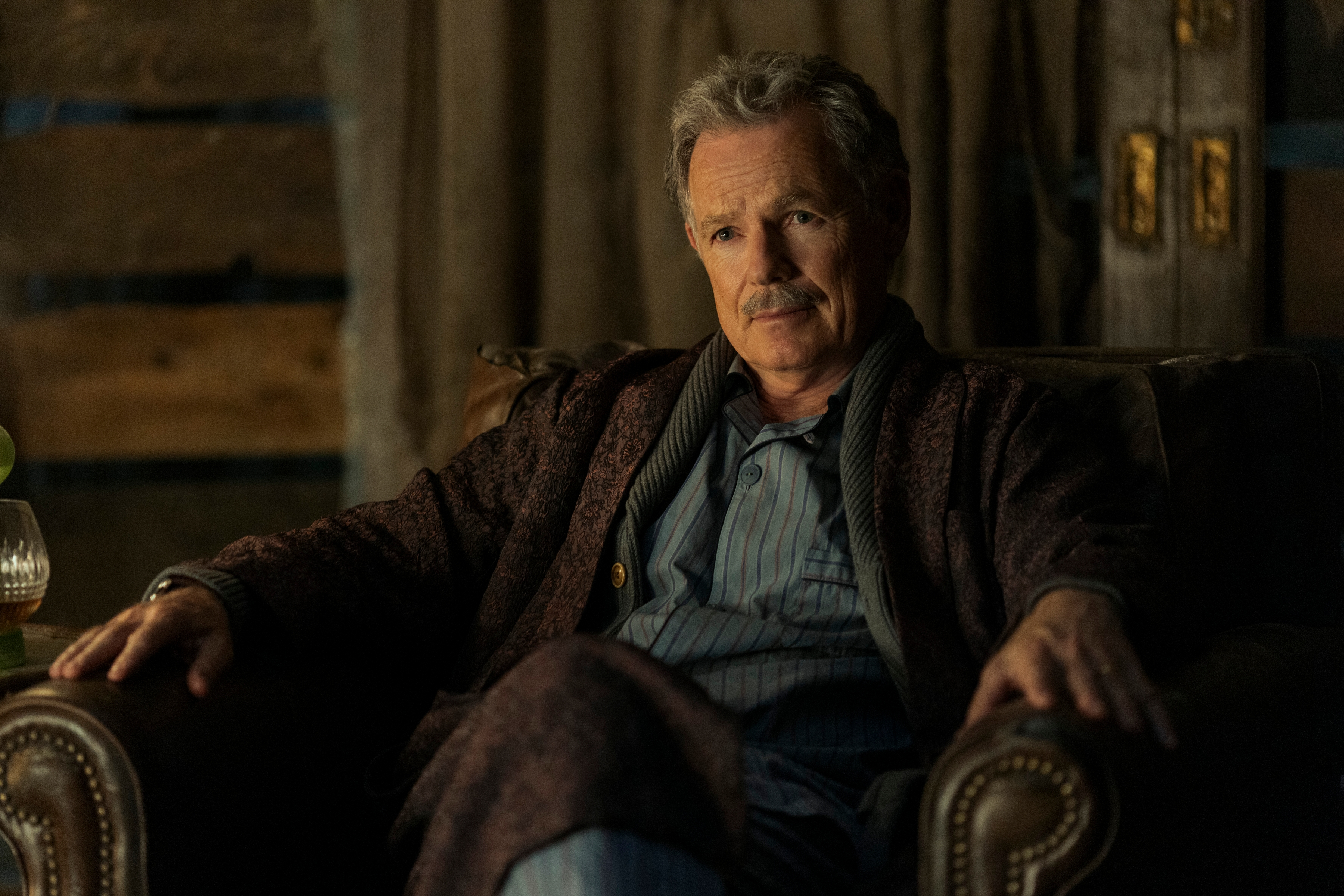 Bruce Greenwood sits in a chair in The Fall of the House of Usher.