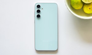 Samsung Galaxy S23 FE Mint Green color along with abowl of lemons.