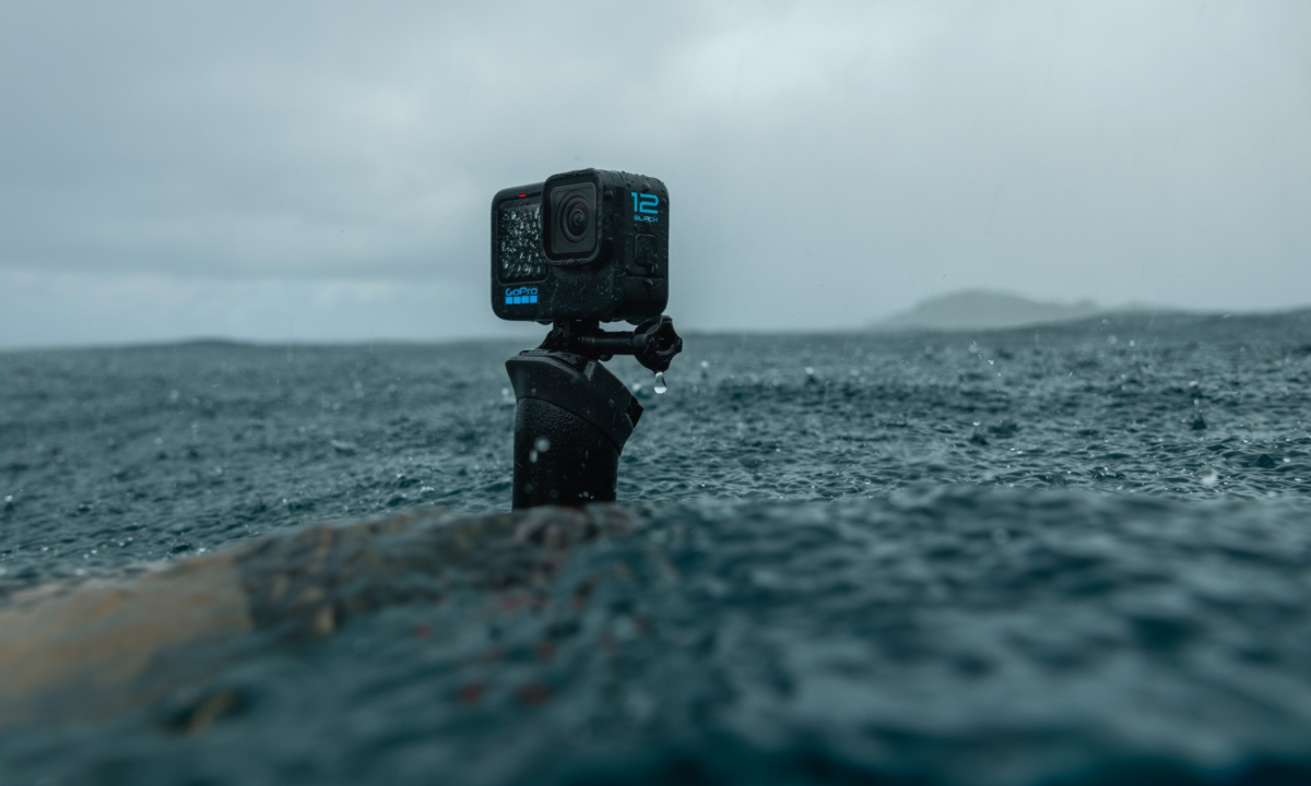 The GoPro Hero 12 action camera recording water on a beach.