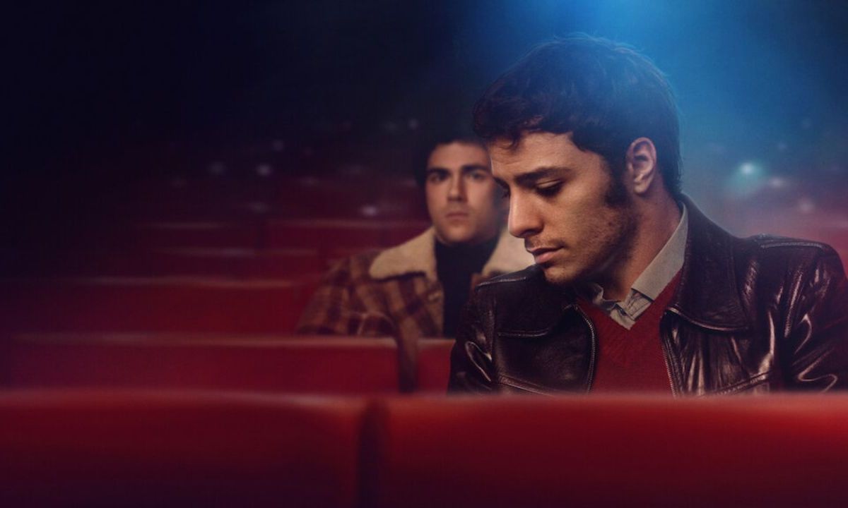 Damiano Gavino and Andrea Di Luigi as Enea and Pietro sitting in an empty theater in the film Nuevo Olimpo.