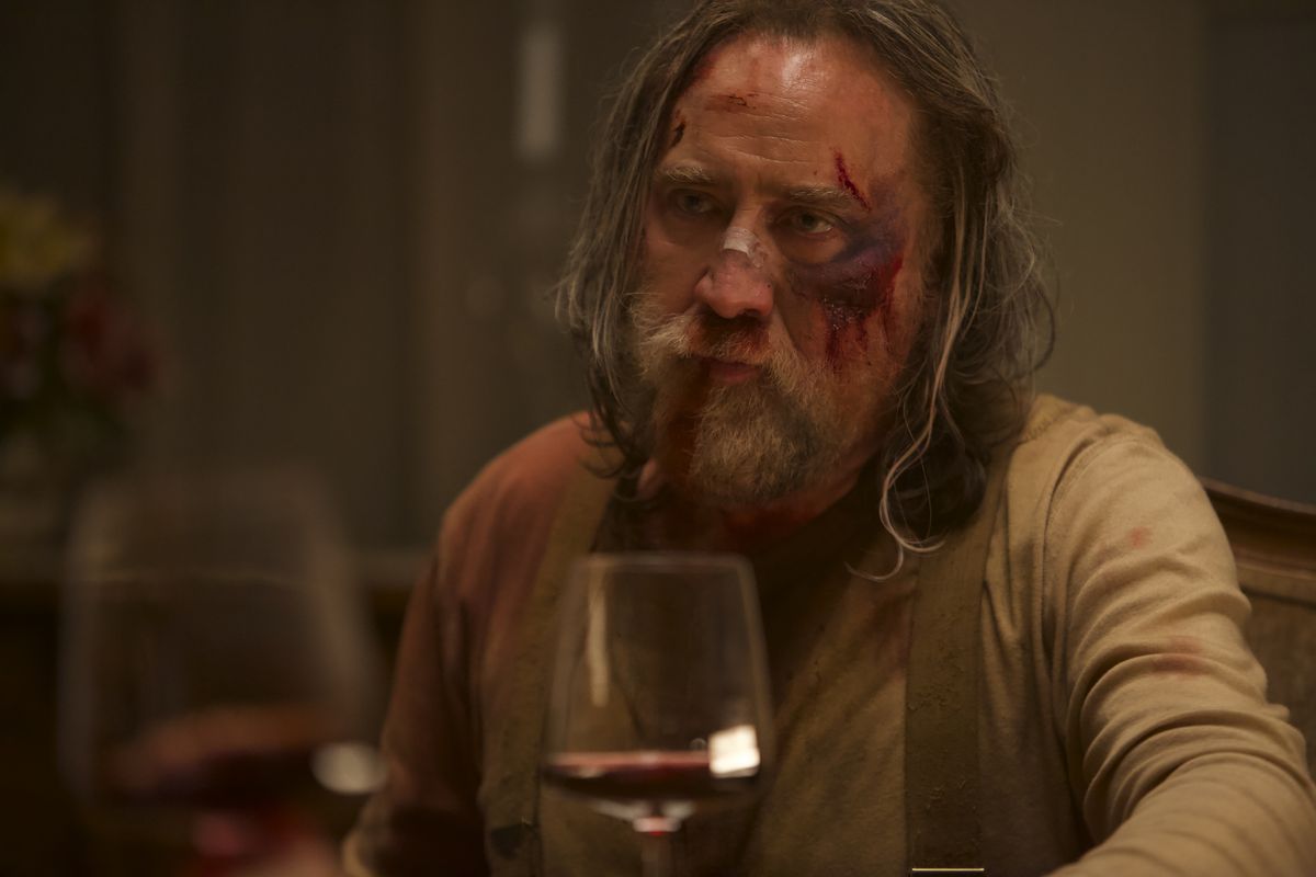 A man sits at a dinner table in Pig.