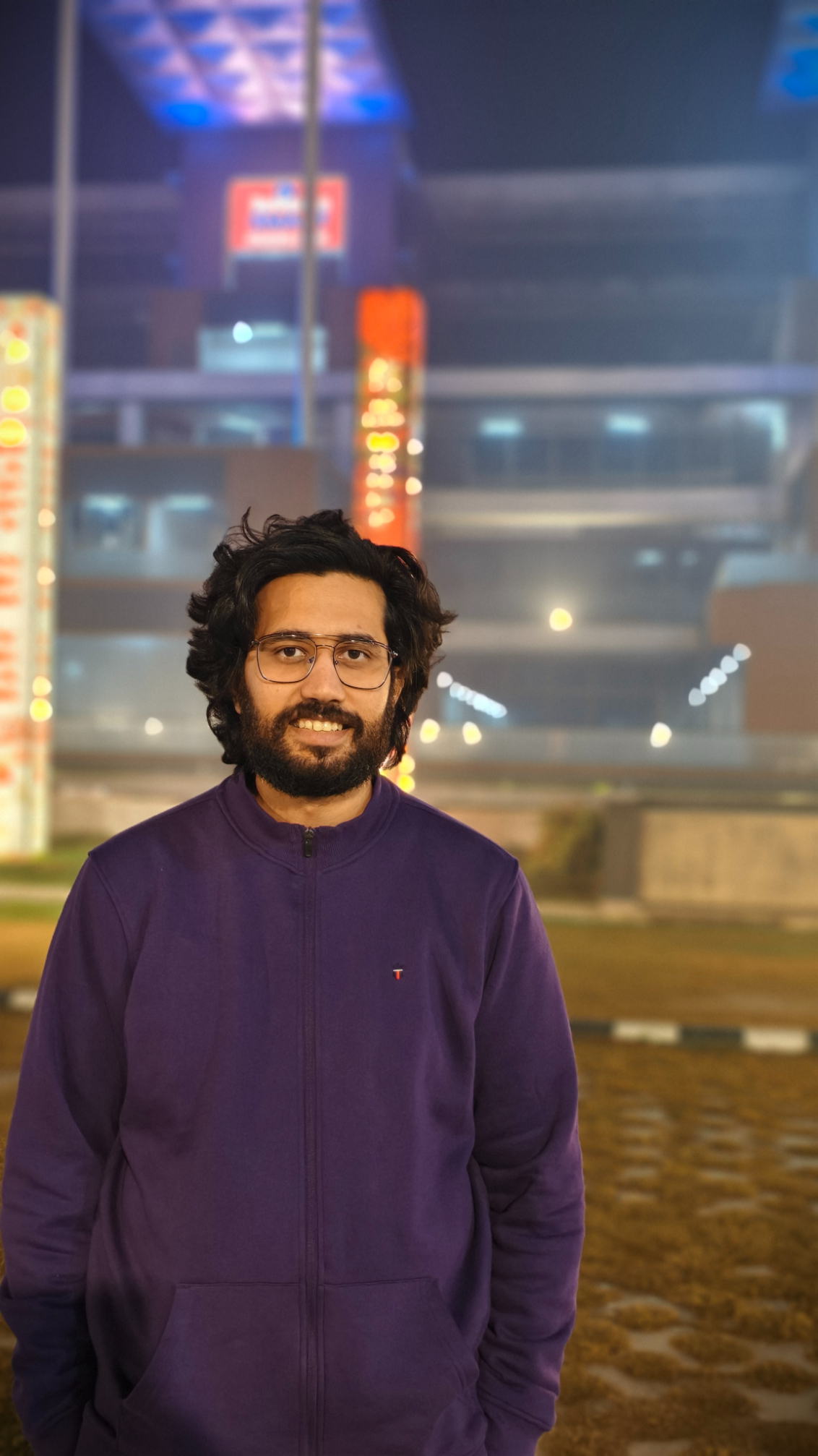 Portrait of a man wearing purple jacket shot on the Vivo X100's Zeiss camera.
