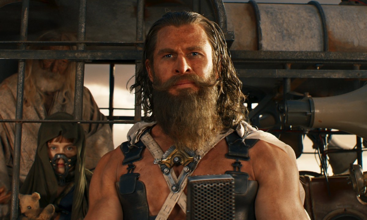 A bearded man looks ahead in Furiosa.