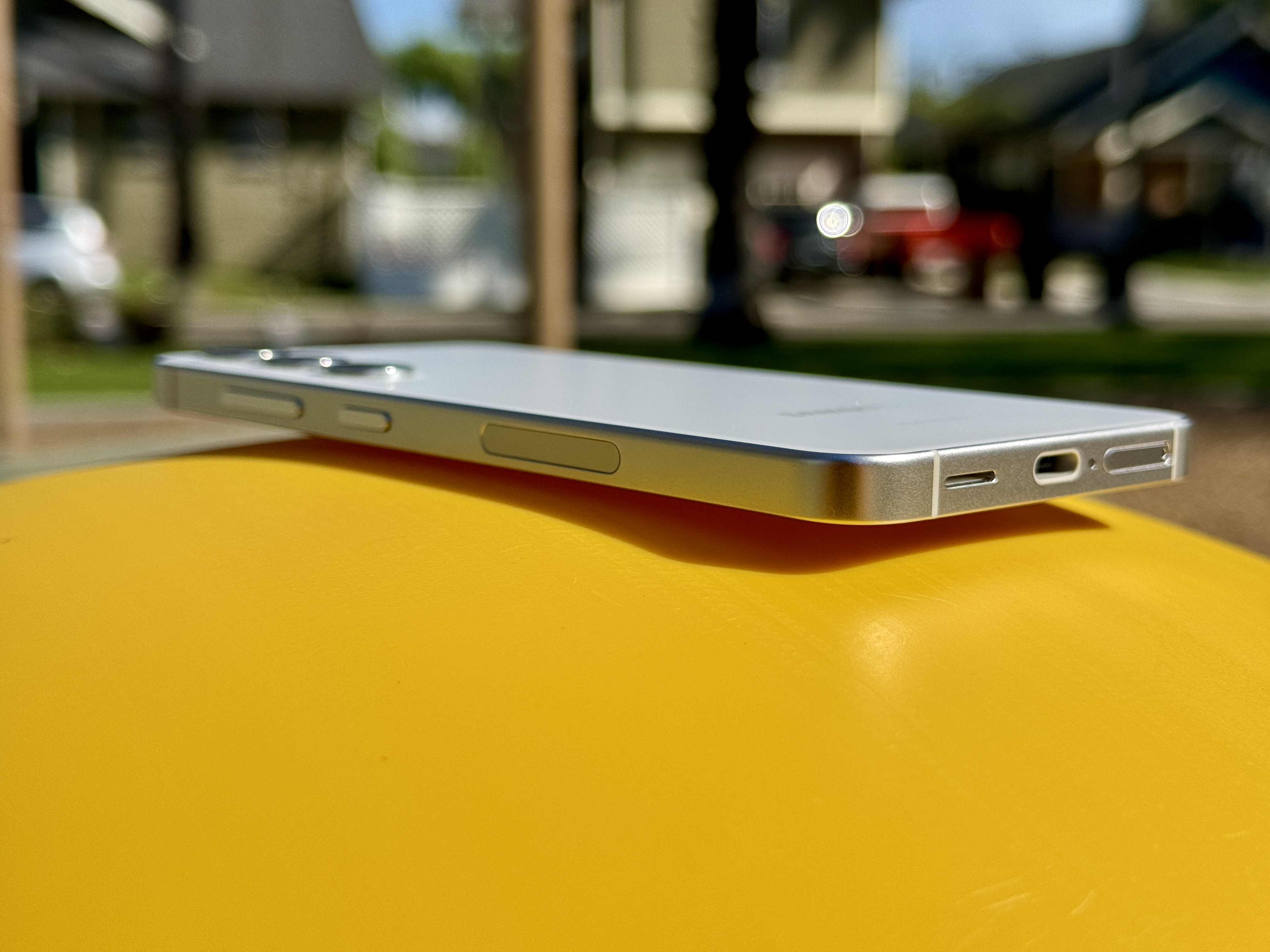 Samsung Galaxy S24 in Marble Gray laying at an angle to show flat frame.