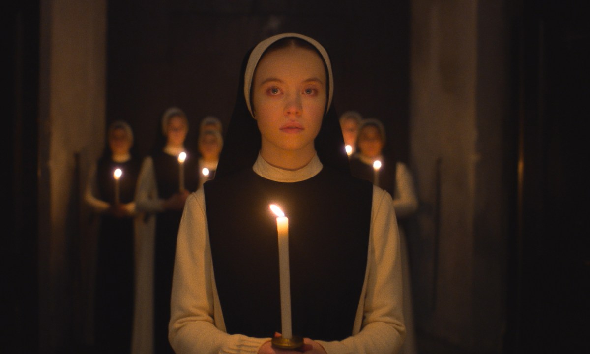 Sydney Sweeney holds a candle in Immaculate.