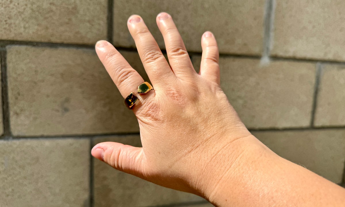 Movano Evie Ring in gold worn on index finger.